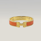Hermès Bracciale Clic H Arancione e Oro in Smalto con Logo H Iconico