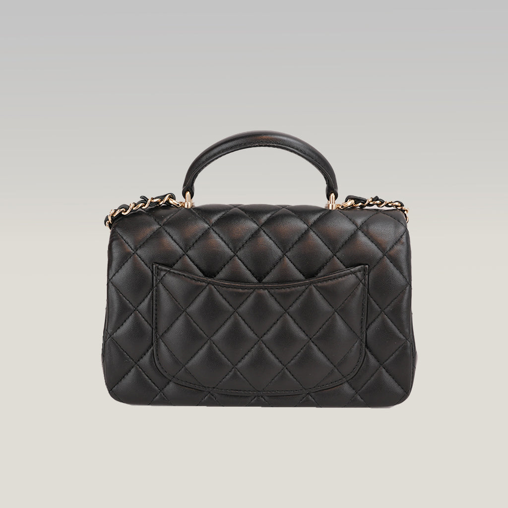 Chanel Mini Classic Flap con Manico in Pelle di Agnello Nera Matelassé e Metallo Dorato