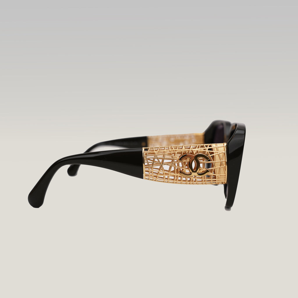 Chanel occhiali da sole neri con aste dorate effetto intrecciato CC