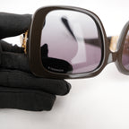 Chanel occhiali da sole neri con aste dorate effetto intrecciato CC