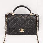 Chanel Mini Classic Flap con Manico in Pelle di Agnello Nera Matelassé e Metallo Dorato