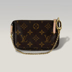 Louis Vuitton Monogram I Rue Scribe Paris Pochette Accessoires Canvas Marrone – Mini Borsa Donna 15 cm