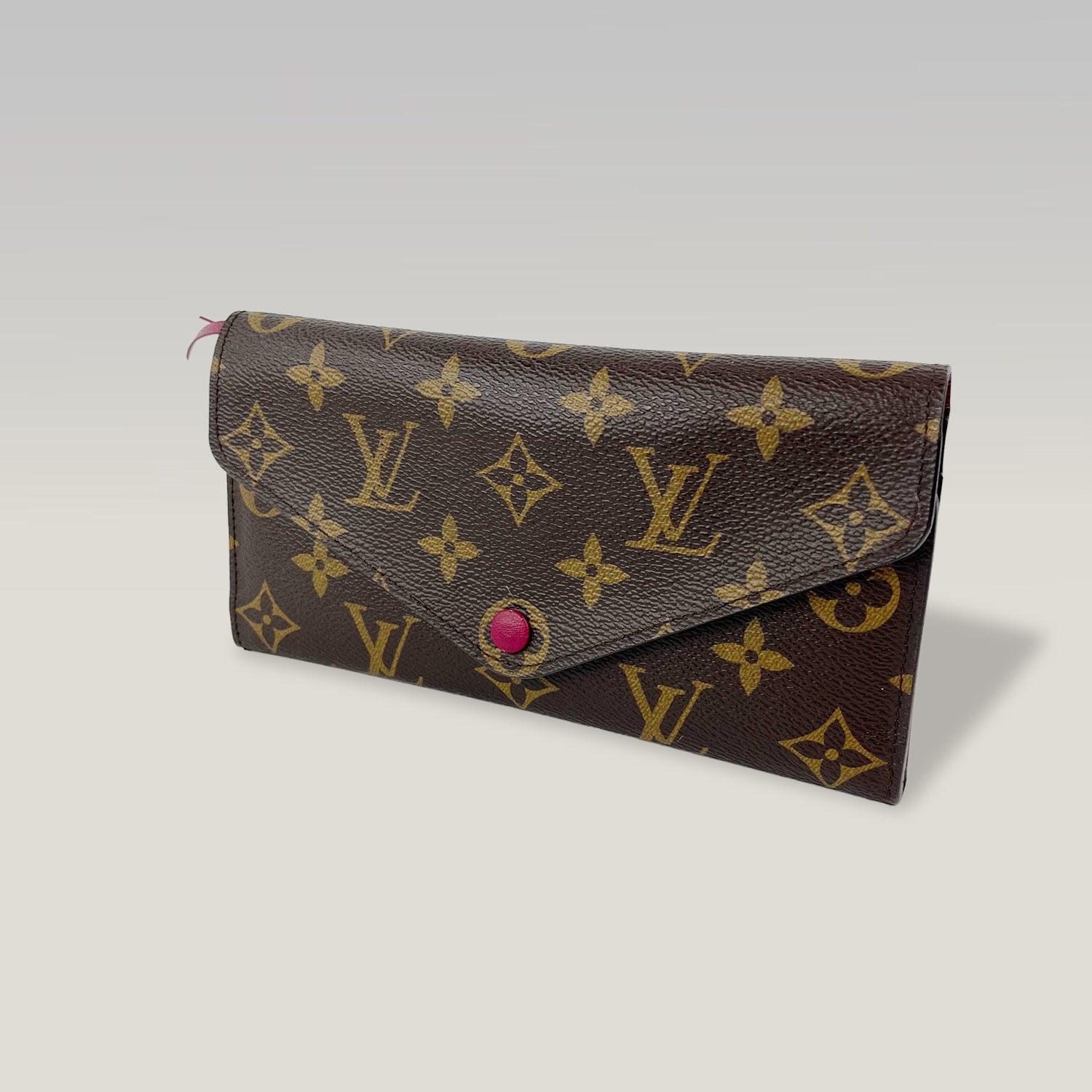 Louis Vuitton portafoglio Monogram con bottone fucsia e tasca estraibile